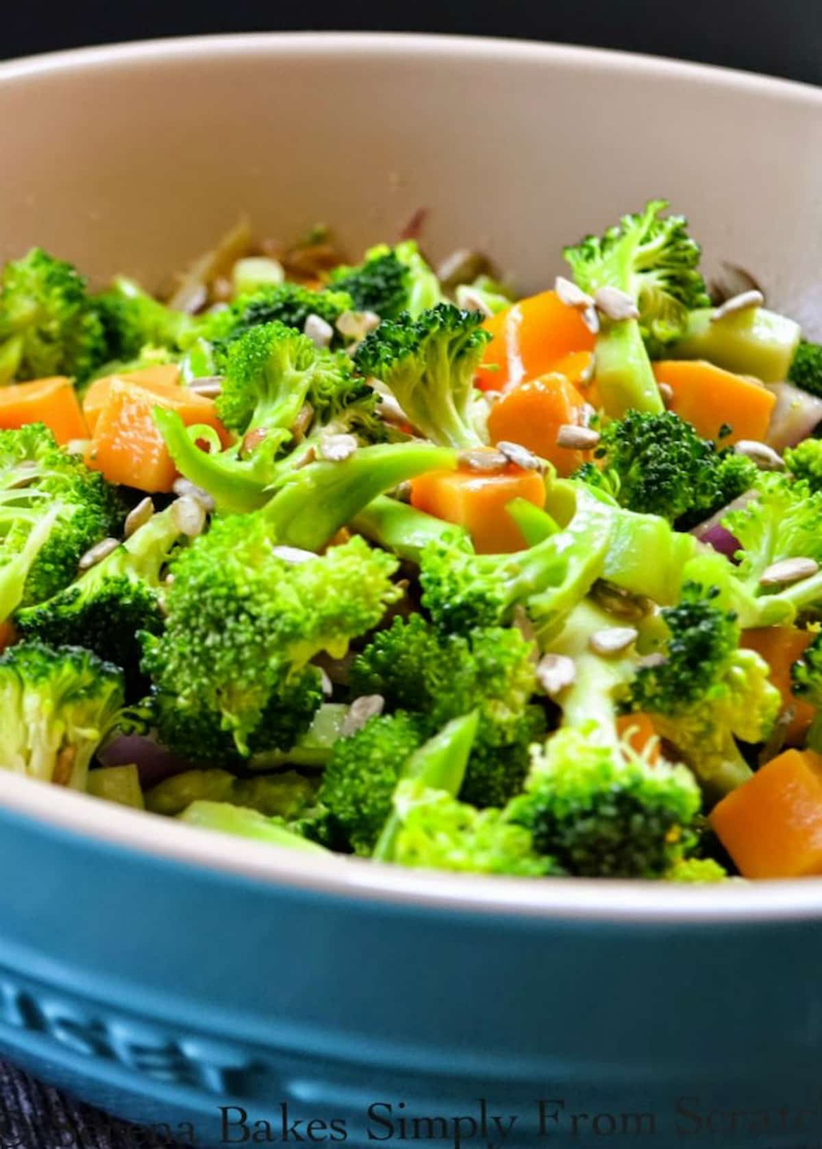 Broccoli Salad in a bowl with sunflower seeds sprinkled on top.
