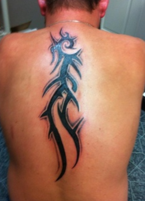Dragon tribal tattoo on back body of man