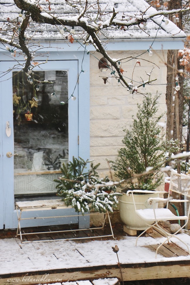 Snow on the deck of the French country garden shed created a magical snowy winter scene