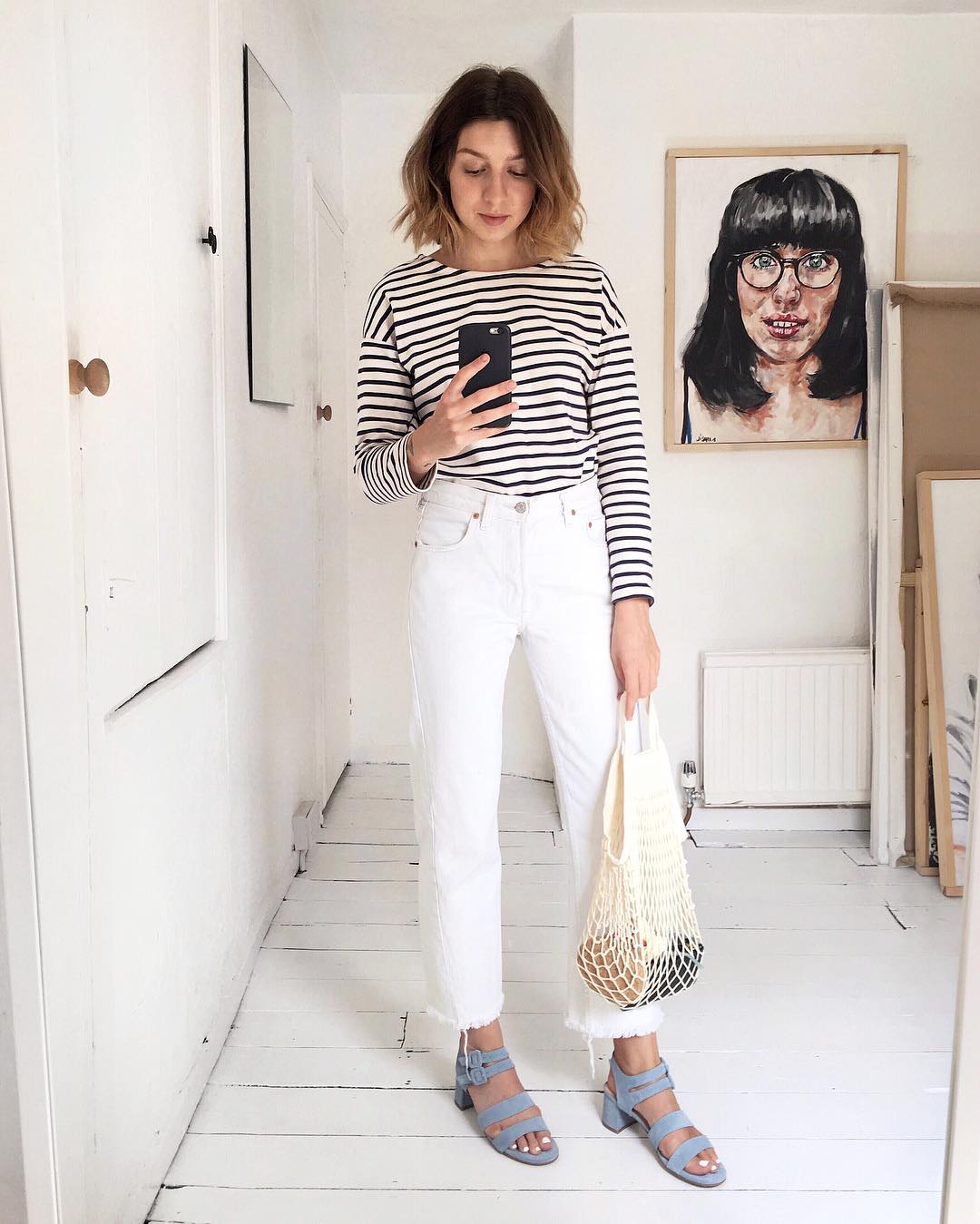 ow to Wear a Striped T-Shirt for Spring — Instagram Outfit Idea with raw-hem white jeans, mesh tote, blue suede sandals