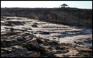 River above Grand Falls with Gazebo across the way to sit and enjoy the Falls.