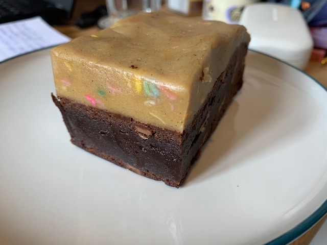 Chocolate brownie, topped with edible raw cookie dough, mixed with funfetti