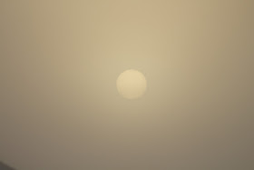 yellow sun through fog