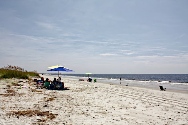 Families relaxing on Oak Island Beach