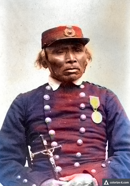An unidentified man in uniform; automatically colorized photograph