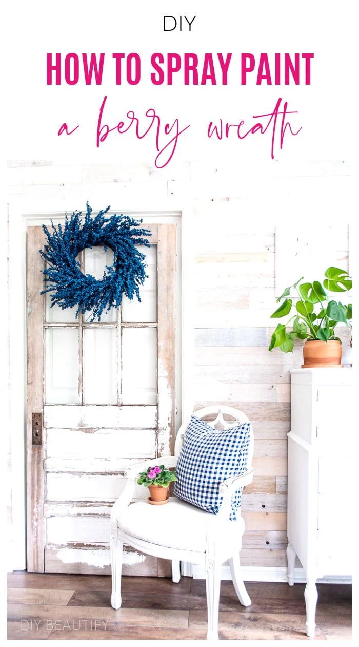 blue berry wreath hung on vintage door in sunroom