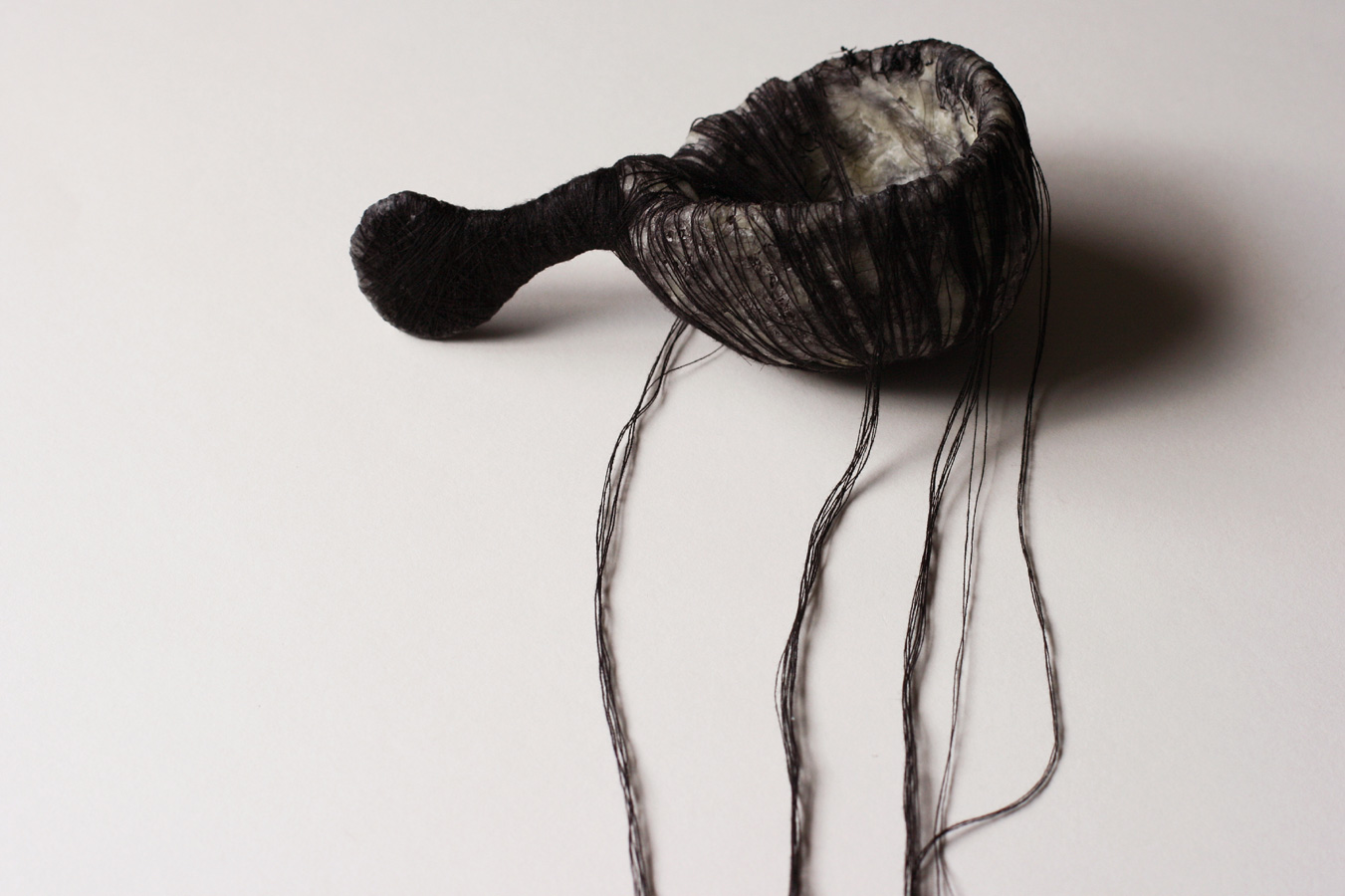 The Black Spoon, 2008. thread, hair, wax, paper & wire.