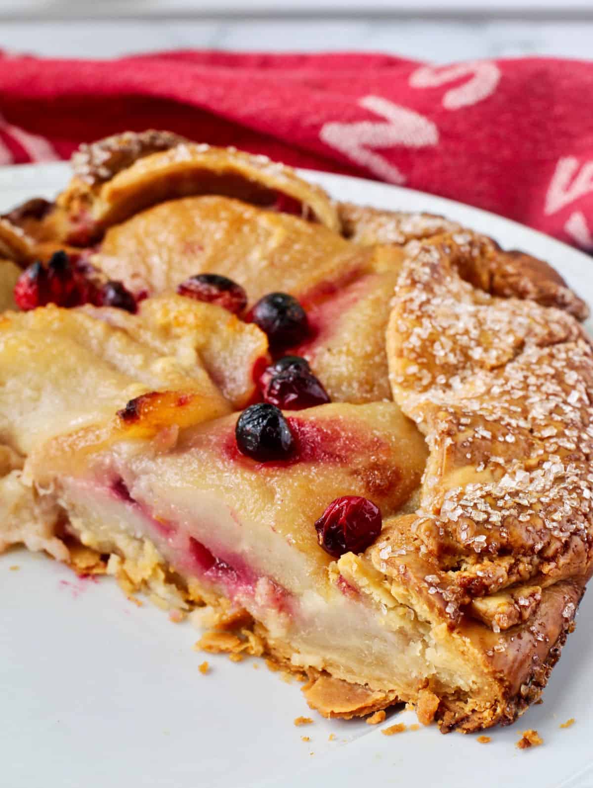 Pear and Cranberry Crostata on a white serving plate.