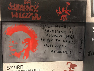 political graffiti in red paint on grey walls