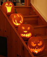 Photo of four pumkins carved by Bill, Karen, Norman, and John