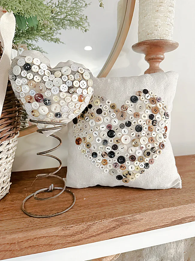 pillows on mantel with vintage spring and candle holder