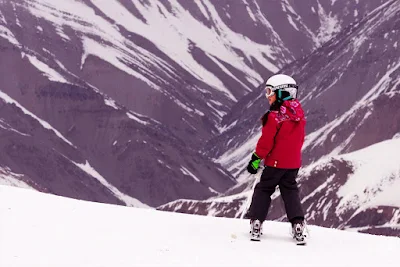 A young girl skiing on the heights of Shemshak Ski resort in Iran.