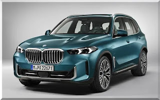 Imagem do volante multifuncional do BMW X5 2024: Nesta imagem, podemos ver o volante revestido em couro e com comandos para as funções do carro, além do painel de instrumentos digital ao fundo.