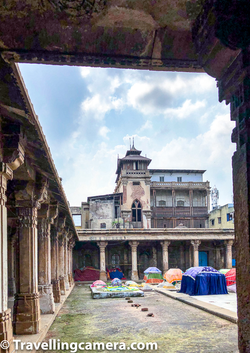It's almost a square space from inside and there are lot of graves of family members of Ahmed Shah, it's chefs and even pigeons. The structures above ground level with colourful pieces of cloth are graves. Height, length and space signifies who these members were. Above photograph shows some of the pillar inside Rani no Hajiro along with view of the old stock exchange of Ahmedabad which is not operational now.     Related blogpost from Gujrat - Panoramic Views of Modhera Sun Temple, Gujrat (India)