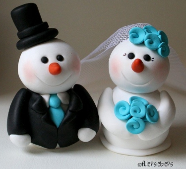 The bride and groom cake topper is handmade out of polymer clay and stands 3 
