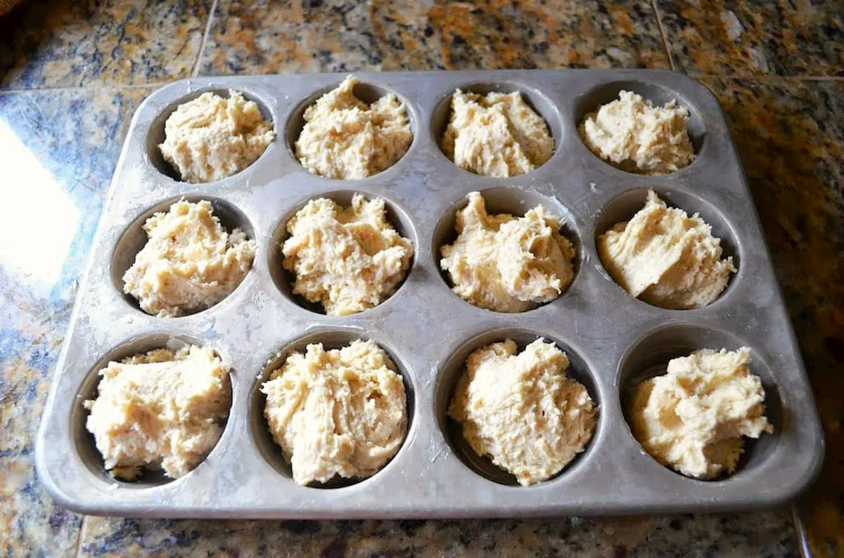 Cinnamon Sugar Muffins batter in a muffin pan tin.