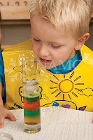 young boy looking at water experiment NAMC montessori parent why choose montessori for my children