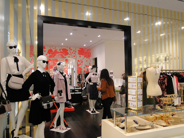 Kate Spade showroom with gold striped walls