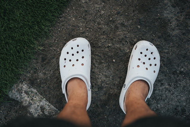 Man's legs with crocs on feet:Photo by Brett Jordan on Unsplash