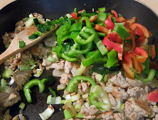 Pile of Multicolored Peppers added to Pan with Meat and Onion