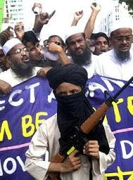 A Muslim child marches with a toy gun to protest the U.S.-led military campaign in Afghanistan after Friday prayers in Dhaka, Bangladesh, Oct.19, 2001. (AP Photo/Pavel Rahman)