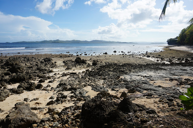 Rokcy beach and gentle waves at a distance at the well-hidden secret spot surfing spot