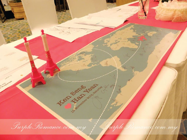 Photo Booth Backdrop Decoration, eiffel tower, guest book, travel around the world theme, wedding, reception table, wooden signage with country names, green carpet, green grass balls, wedding poster, welcome board with country passport stamps, initial, london bags, white fences, aeroplane, cute, clouds, Kuala lumpur, mandarin oriental hotel, selangor