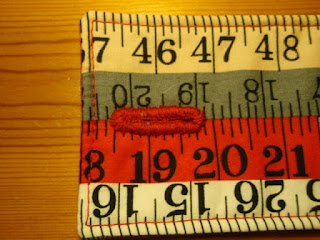 Hand stitched button hole