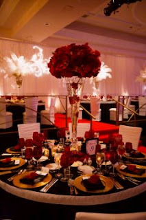If you are daring brides who want to leave the mainstream of white, cream, ivory and other traditional wedding colors, we present a series of floral arrangements or centerpieces with flowers or red motifs, sure you will choose one for the day your celebration.  In these first two models have long stylized vases inside which carry a red color and detail on top a kind of bouquet of roses the same color.    The difference with the first sample is that it has branches inside the vase.    Elegant centerpiece with branches and red flowers attached to them, to add the necessary brightness will have round lenses.   Elegant, simple and sophisticated, this square glass bowl at the base and red rosebuds on top is definitely a beautiful detail that perfectly complements the other four containers with candles.    Another original centerpiece with flowers at the base, as a skirt, and as many submerged into the vase.    Simple and ideal for informal celebrations are 4 different height vases with red liquid inside and a simple white flowers on long stems inside.     A variation of the above centerpiece, the difference is the size of these, being more short, thin, white flower that covers highlights and its effect is more striking.      Another simple centerpiece with red and green candles around play an important role.    Curious centerpiece placed on some books, is ideal for themed weddings that are related to these texts.    Finally, the perfect combination of flowers, pearls and crystal.    I hope you enjoyed.