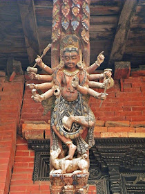 Wood carved temple strut depicting a hindu deity in Nepal