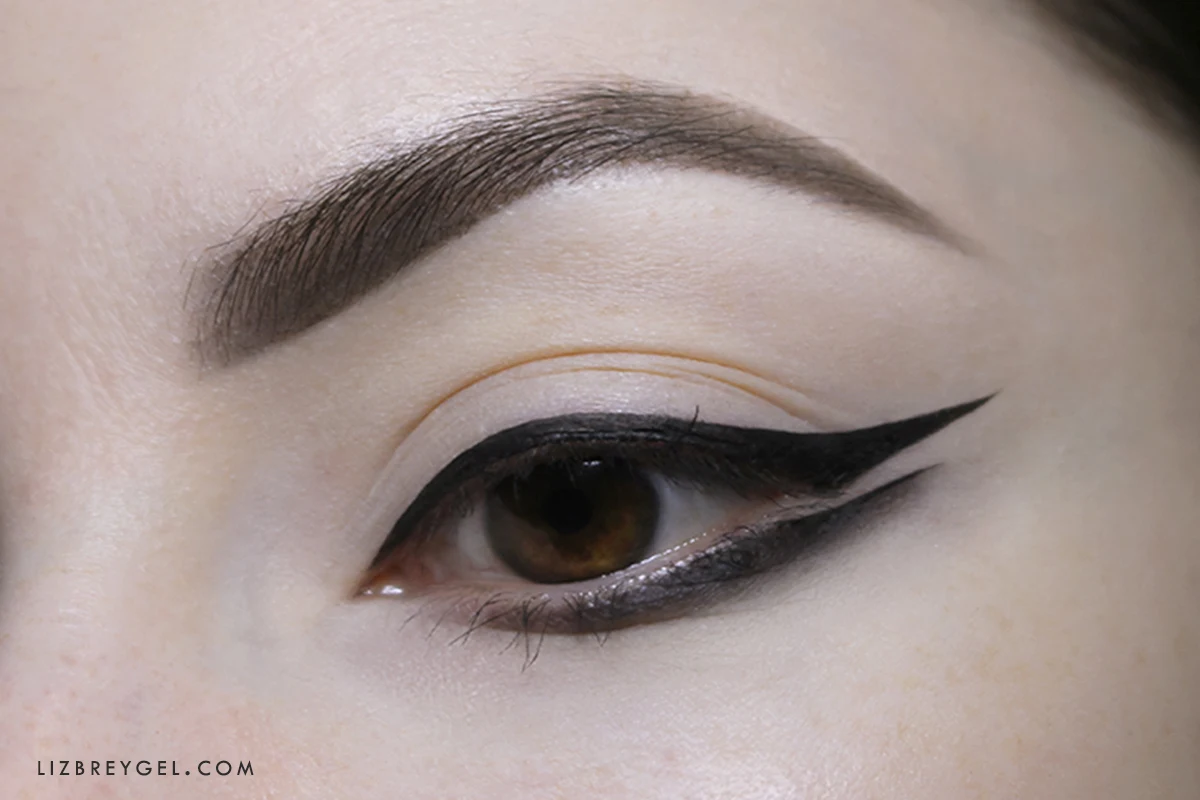 a close-up of an opened woman's eye with a spling eyeliner look