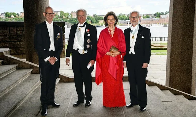 Queen Silvia wore a red lace gown dress. The Sjöberg Prize in Cancer Research. King Carl Gustaf