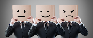3 men in black suits holding pictures of expressions (indifference, like, dislike) blocking their faces