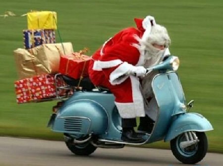 Funny+santa+claus+with+gifts+on+scooter.jpg