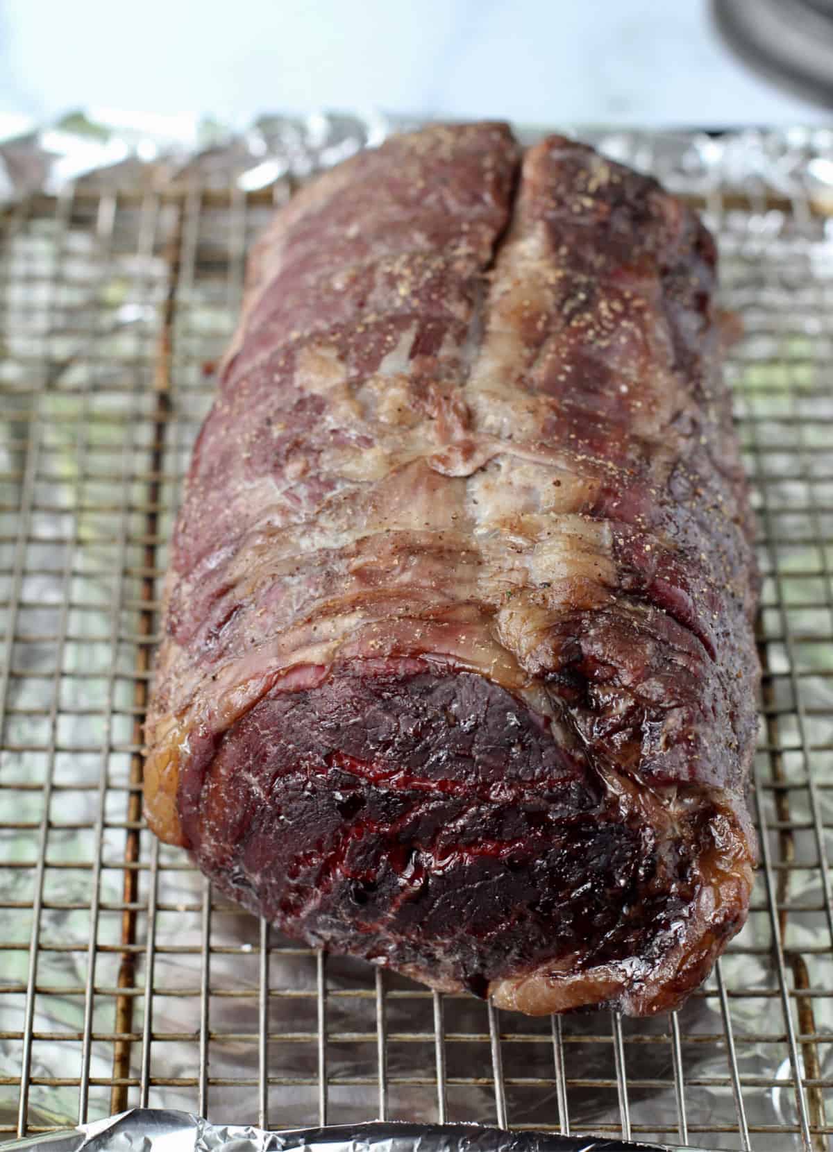 Beef tenderloin on a rack after roasting.