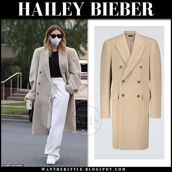 Hailey Bieber in beige coat and white sweatpants