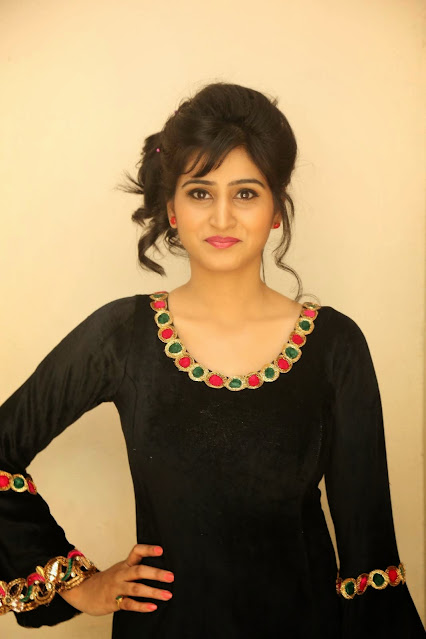 Varshini Sounderajan looking chic in a black outfit, a picture of elegance.