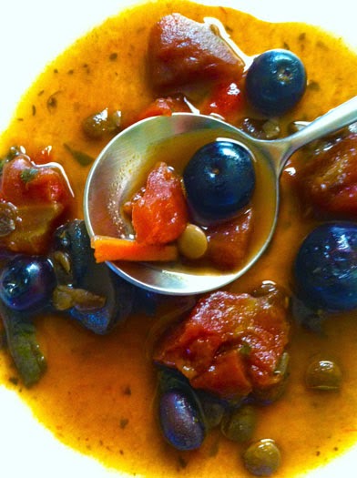 Tasting plate of black bean and lentil soup with blueberries