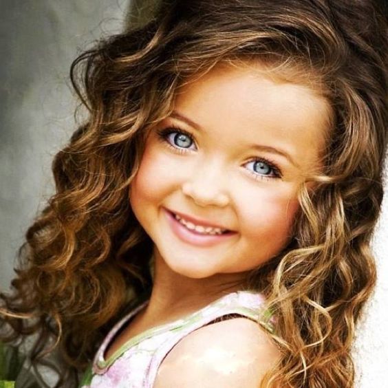 Cute Baby Girl with Blue Eyes and Curly Hair