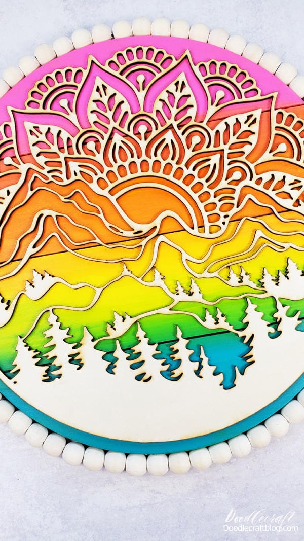How to Make a Mountain Sunset Mandala  This mountain sunset mandala art is the perfect Summer craft!   It's got all the late night/camping/sunset in the mountains vibes.   I'm a beach girl in my mind, but my budget and location make me a mountain girl.   Let's make this gorgeous wall art piece in just a few minutes!    Learn How to Make a Mountain Sunset Mandala Wood Pallet!