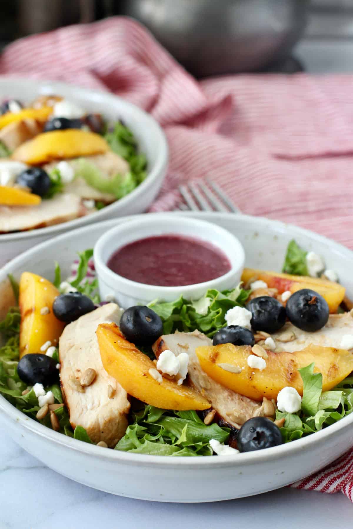 Grilled Chicken and Peach Mixed Green Salad in bowls.