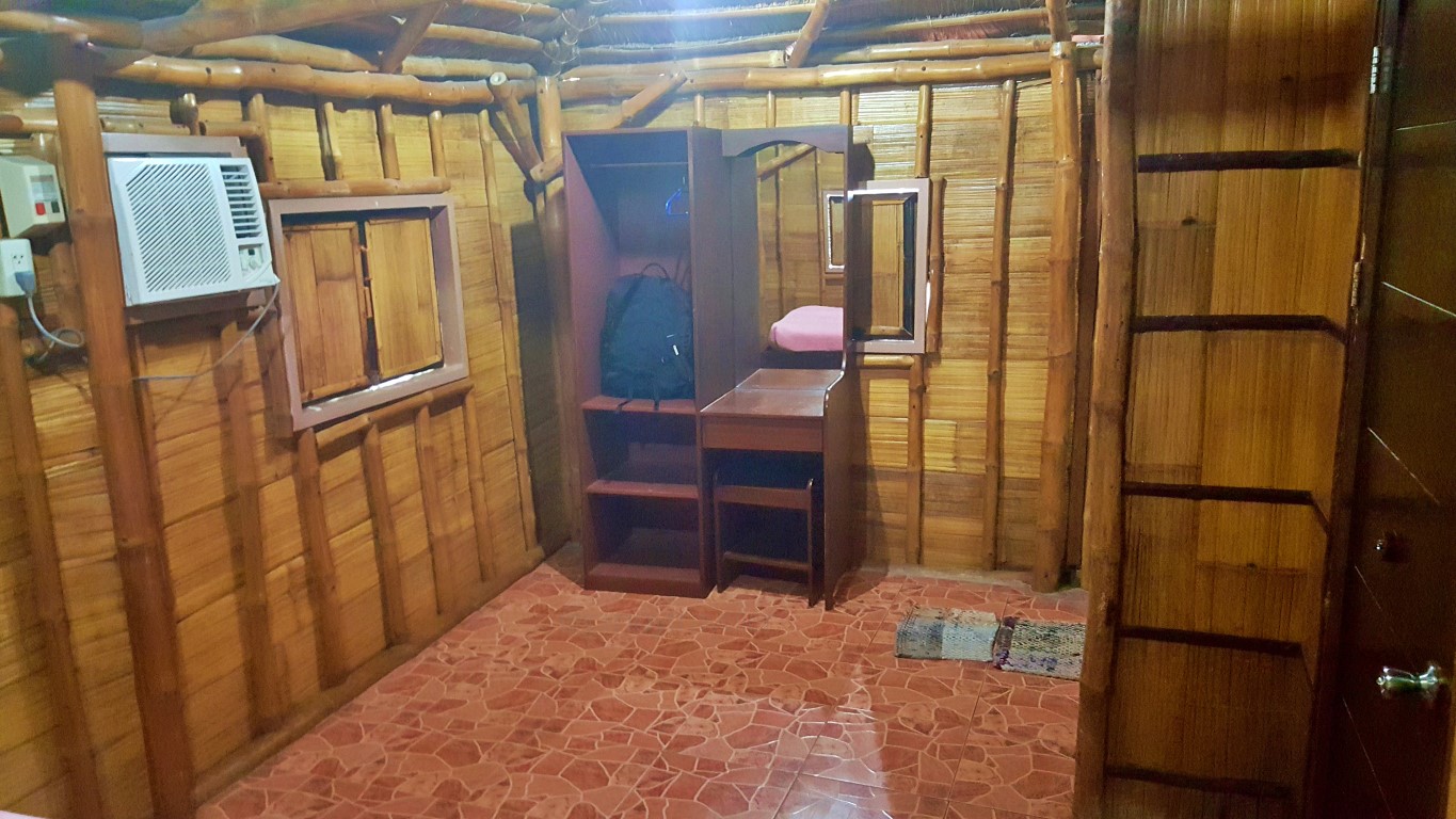 bedroom of Cottage D1 at Isla Jardin Del Mar Resort in Glan, Sarangani