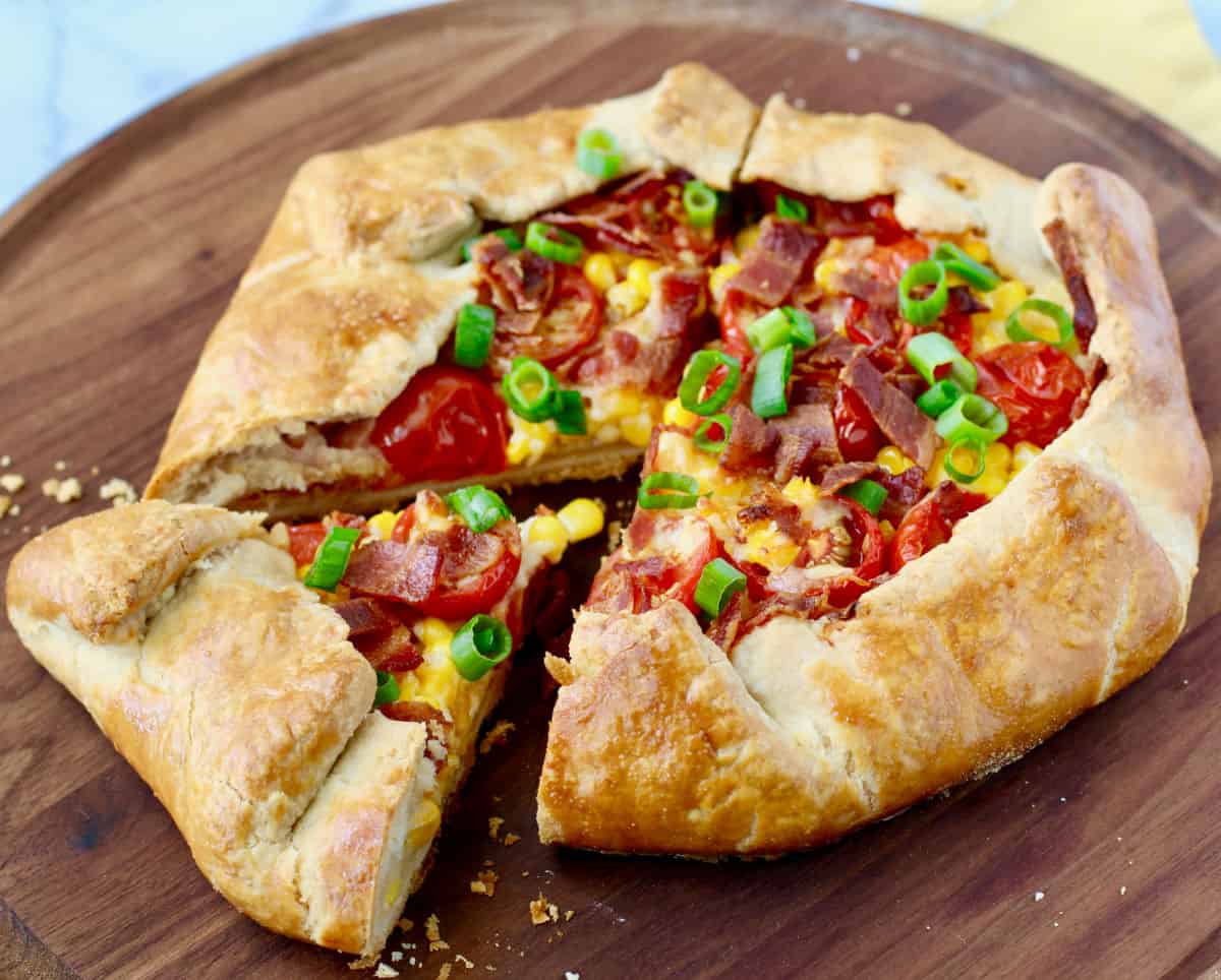 Bacon, Tomato, and Corn Galette with a slice cut out.