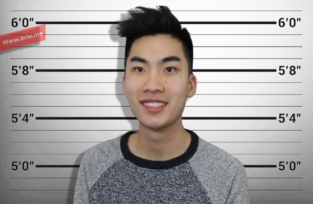 RiceGum posing in front of a height chart