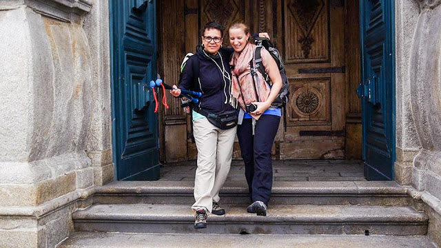 duas peregrinas de Santiago de Compostela saindo da igreja