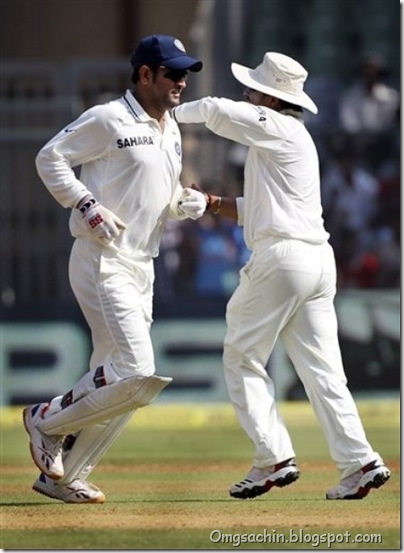 ndian cricket captain Mahendra Singh Dhoni, left, celebrates with teammate Sachin Tendulkar the wicket of West Indies player Kirk Edwards during the second day of the third test cricket match in Mumbai, India,