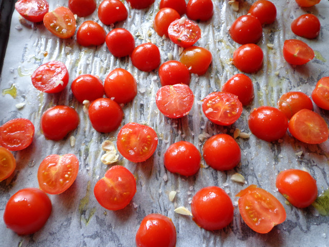 Place cherry tomato halves on a baking sheet