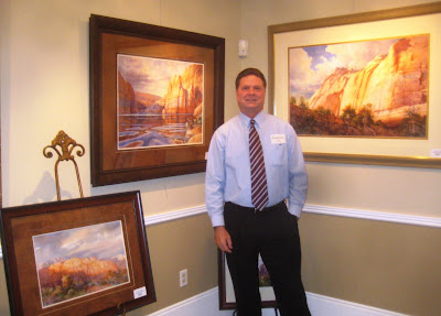 Roland Lee by his paintings at the Canyon Country art exhibit