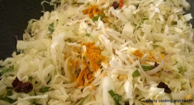 Adding white cabbage and turmeric powder.