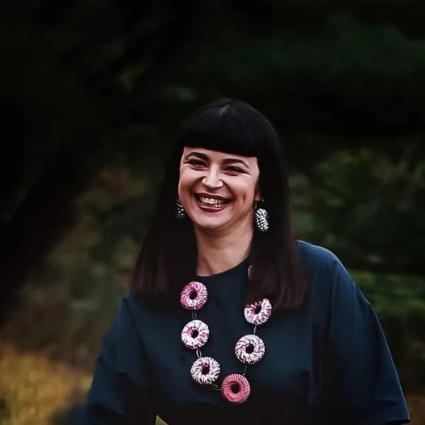 smiling Francesca Vitali wearing large necklace of woven circles